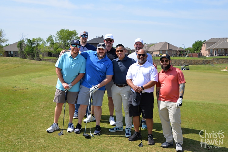 group posing at golf tournament