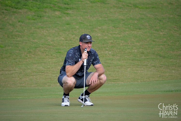 Golfer contemplating putt